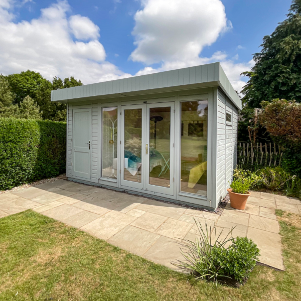 Salthouse Studio with Shed Storage A grey modern garden studio with floor to ceiling windows and an extended end with external single door